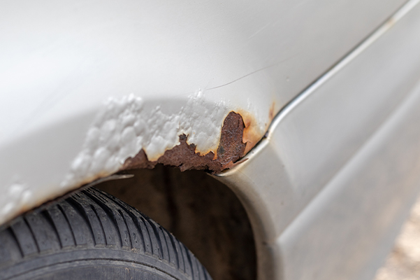 Rust on a silver car over the wheel
