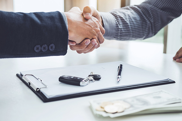 Handshake of cooperation customer and salesman after agreement, successful car loan contract buying or selling new vehicle
