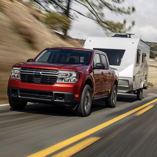 Ford maverick in motion towing a camper