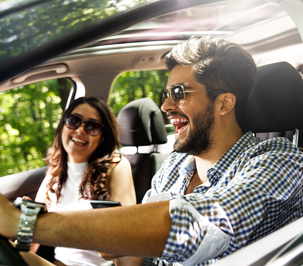 Young couple riding in a car
