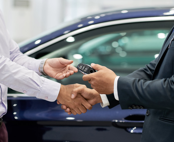 Handshake from dealer handing over car keys
