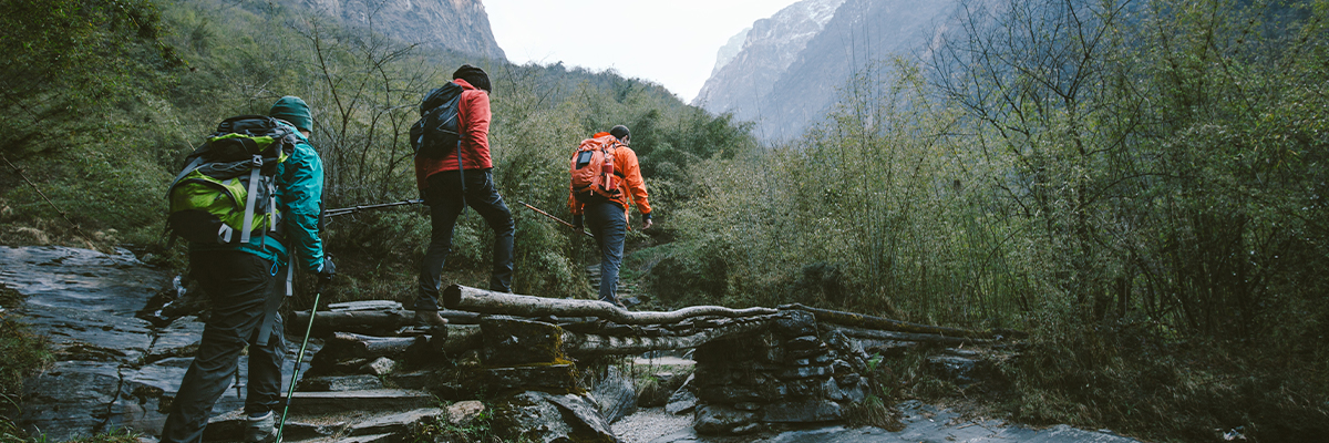 Group of people hiking through mountains