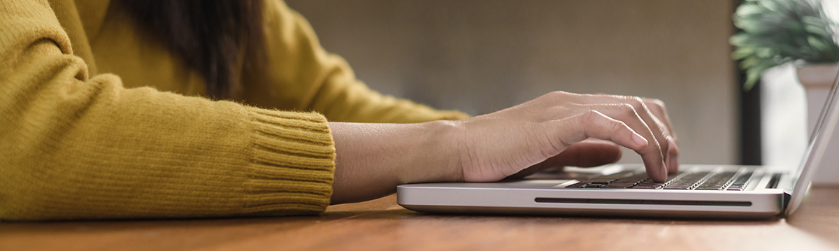 Young woman working with the laptop looking for new car