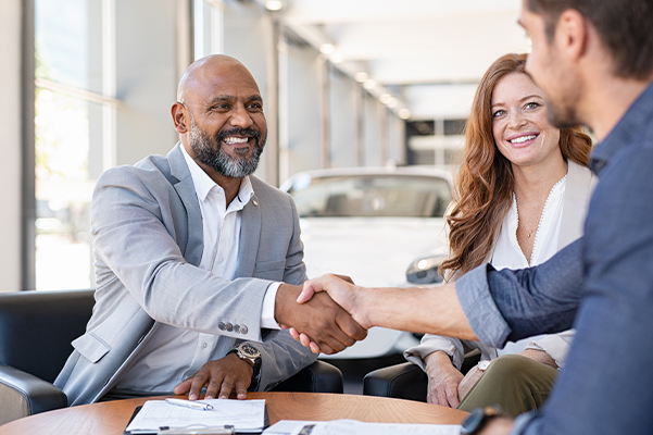 Couple buying new car at car dealership